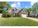 Beautiful brick home boasts well-maintained lawn, two-car garage, and inviting curb appeal at 272 William Nye Se Dr, Atlanta, GA 30315