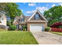Charming two-story home with brick facade, manicured lawn, and attached two-car garage at 272 William Nye Se Dr, Atlanta, GA 30315
