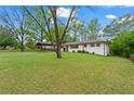 Landscaped property showcasing brick home with shutters and spacious front yard at 605 Rocky Branch Rd, Villa Rica, GA 30180