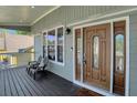Inviting front porch with seating area and a beautifully crafted front door with sidelights at 1035 Avalon Dr, Lawrenceville, GA 30044