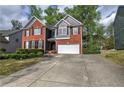 Beautifully landscaped front yard and long driveway leading up to a two-story brick and gray home at 4111 Mcever Woods Nw Dr, Acworth, GA 30101