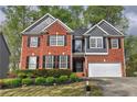 Charming two-story brick home with a manicured lawn and a two-car garage in a desirable neighborhood at 4111 Mcever Woods Nw Dr, Acworth, GA 30101