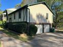 Two-story home featuring an attached two-car garage and mature landscaping at 4152 Scenic Mountain Dr, Snellville, GA 30039