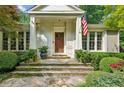 Inviting front entrance with a custom wood door, stone steps, and beautifully maintained shrubbery at 2726 Mabry Ne Rd, Atlanta, GA 30319