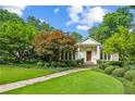 Charming home with meticulous landscaping, featuring a stone pathway and vibrant green lawn at 2726 Mabry Ne Rd, Atlanta, GA 30319