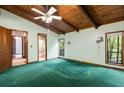 Bedroom with wood ceiling, green carpet, and windows letting in natural light at 3450 Brookhill Cir, Marietta, GA 30062