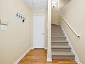Entryway staircase with beige walls, carpeted stairs and wood flooring at 5213 Pinnacle Point Ct, Norcross, GA 30071