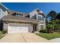 Charming two-story home with stone accents, neutral siding, and a well-maintained lawn, complemented by a two-car garage at 1809 Park Land Ln, Snellville, GA 30078