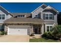 Charming two-story home with stone accents, neutral siding, and a well-maintained lawn, complemented by a two-car garage at 1809 Park Land Ln, Snellville, GA 30078
