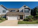 Charming two-story home with stone accents, neutral siding, and a well-maintained lawn, complemented by a two-car garage at 1809 Park Land Ln, Snellville, GA 30078
