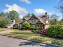 Charming two-story home with landscaped yard, circular driveway, and classic architectural details at 3018 Bradshaw Club Dr, Woodstock, GA 30188