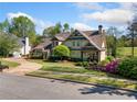 Charming two-story home with landscaped yard, circular driveway, and classic architectural details at 3018 Bradshaw Club Dr, Woodstock, GA 30188