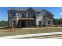 Charming two-story brick home with manicured lawn and landscaping at 157 Longhorn Way, Auburn, GA 30102