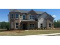 Beautiful two-story brick home with well-manicured lawn at 157 Longhorn Way, Auburn, GA 30102