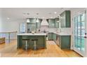Modern kitchen featuring green cabinets, stainless steel appliances, and a center island at 4554 Meadow Valley Dr, Atlanta, GA 30342