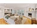 Bright and airy living room boasts a cozy fireplace, hardwood floors, and backyard access at 4554 Meadow Valley Dr, Atlanta, GA 30342