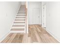 Bright entryway with wood flooring and a staircase leading to the upper level. Perfect for a grand entrance at 490 Hammons Way, Atlanta, GA 30315
