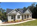 Beautiful house with a manicured lawn and inviting front porch with stone and siding accents at 31 Cedar Gate Ln, Kingston, GA 30145