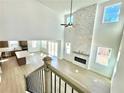 Soaring living room with fireplace, large windows and a view into the kitchen and dining area at 719 Crossroad Ct, Powder Springs, GA 30127