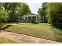 Inviting one-story home with a well-manicured lawn and a classic front porch at 1104 Victory Sw Dr, Atlanta, GA 30310