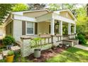 Close-up of a welcoming home with a charming front porch and beautiful landscaping at 1104 Victory Sw Dr, Atlanta, GA 30310