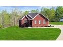 Charming red brick home featuring a well-manicured lawn and lovely landscaping at 896 Winn Rd, Douglasville, GA 30134