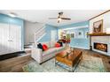 Comfortable living room with fireplace, ceiling fan, and open floor plan at 10900 Wittenridge Dr # C1, Alpharetta, GA 30022
