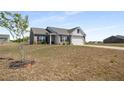 Charming brick home featuring stone accents, a two-car garage, and a well-manicured lawn at 1259 Fendt Dr, Locust Grove, GA 30248