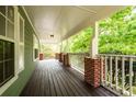 Spacious covered front porch features wood decking and brick supports at 1412 Woodbine Se Ave, Atlanta, GA 30317