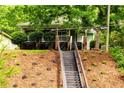 Charming front yard featuring landscaped hillside and steps up to the home at 1412 Woodbine Se Ave, Atlanta, GA 30317