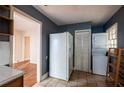 Roomy kitchen featuring a refrigerator, a stacked washer/dryer, and tile flooring at 1594 Lincoln Se Ave, Atlanta, GA 30317