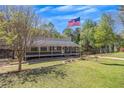Beautiful home featuring well-maintained lawn, mature trees, and American flag at 507 Honeysuckle Ln, Woodstock, GA 30188