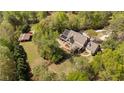 Aerial view of a sprawling property with a house, pool, outbuilding, and lush greenery at 2839 Echols Rd, Cumming, GA 30041
