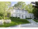 Attractive white exterior with dormer windows and landscaped front yard provides classic charm at 315 Peachtree Battle Nw Ave, Atlanta, GA 30305