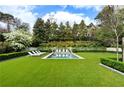 Beautiful backyard pool area with lounge chairs and lush green lawn offers a relaxing outdoor retreat at 315 Peachtree Battle Nw Ave, Atlanta, GA 30305
