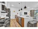 Modern kitchen with central island and open layout flowing into the living area at 112 Rogers Ne St # 207, Atlanta, GA 30317