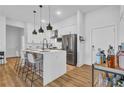 Modern kitchen with stainless steel appliances, pendant lighting, and sleek white countertops at 112 Rogers Ne St # 207, Atlanta, GA 30317