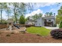Large backyard with a play structure, patio, and plenty of green space for outdoor activities at 1861 8Th St, Atlanta, GA 30341