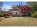 Inviting two-story home with classic design, well-maintained lawn, and a beautiful maple tree at 645 Iroquois Ne Dr, Marietta, GA 30060