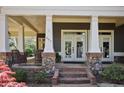 Close up of the home's porch, with stone accents, seating, and a brick pathway at 645 Iroquois Ne Dr, Marietta, GA 30060