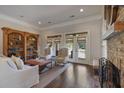 Bright living room featuring hardwood floors, built-in bookcase, and a cozy fireplace at 645 Iroquois Ne Dr, Marietta, GA 30060