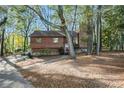 Charming house with wood siding, nestled among mature trees in a serene, wooded setting with stone foundation at 2763 Macby Walk, Marietta, GA 30066