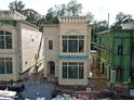 Two-story home with large windows, detailed trim, and an arched entryway at 11863 Serenbe Ln, Chattahoochee Hills, GA 30268