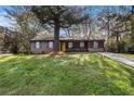 Charming single-story home with a well-maintained lawn, inviting curb appeal, and a bright yellow front door at 2760 Swansea Ct, College Park, GA 30349