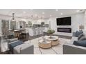 Bright, open living space with modern decor, fireplace, and stylish kitchen in the background at 2760 Swansea Ct, College Park, GA 30349
