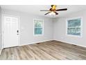 Bright bedroom featuring neutral paint, ceiling fan, and laminate flooring at 299 Ard Nw Pl, Atlanta, GA 30331