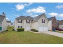 Charming two-story house with a well-kept lawn, two-car garage, and a welcoming front entrance at 3943 Brookgate Ct, Ellenwood, GA 30294