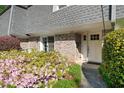 Charming townhouse entrance with a white door framed by blooming azaleas at 1152 Hampton Ne Way, Atlanta, GA 30324