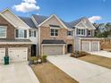 Beautiful townhome with brick and siding exterior, showcasing a one-car garage at 1307 Park Center Cir, Austell, GA 30168