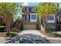 Beautiful brick townhome featuring an attached garage and well-manicured landscaping at 1016 Manchester Way # 43, Roswell, GA 30075